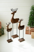 SET OF THREE CARVED WOOD AND IRON REINDEER ON BASES