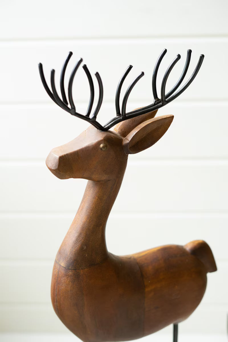 SET OF THREE CARVED WOOD AND IRON REINDEER ON BASES