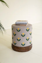 Grey Upholstered Ottoman with Embroidered Detail and Carved Wood Base