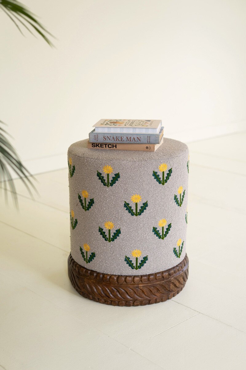 Grey Upholstered Ottoman with Embroidered Detail and Carved Wood Base